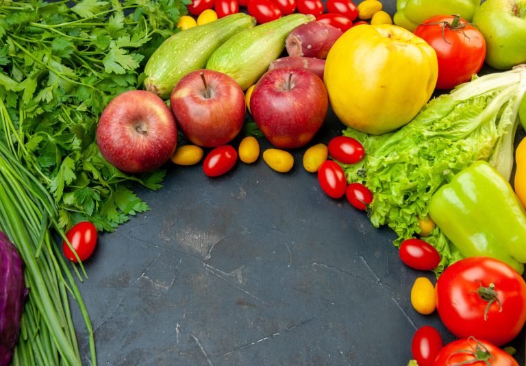 bottom-view-vegetables-fruits-cherry-tomatoes-cumcuat-apples-green-onion-lettuce-parsley-bell-peppers-with-copy-place